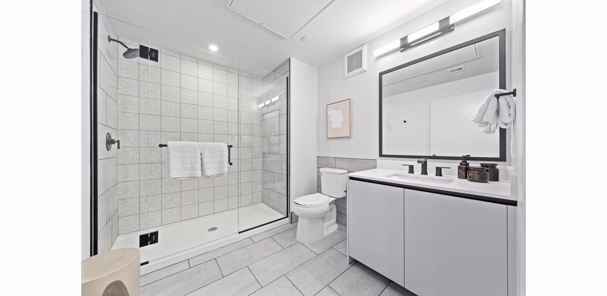 Modern bathroom with elegant fixtures and large mirrors at The Monde Scottsdale Apartments