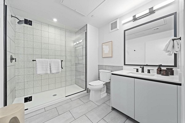 Modern bathroom with elegant fixtures and large mirrors at The Monde Scottsdale Apartments