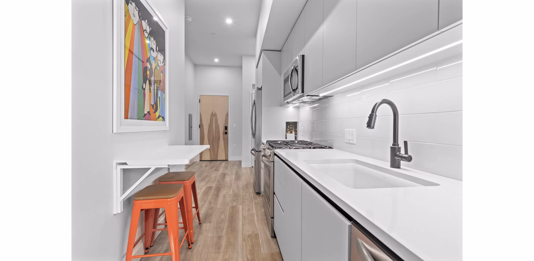 Modern kitchen with stainless steel appliances and granite countertops at The Monde Scottsdale Apartments