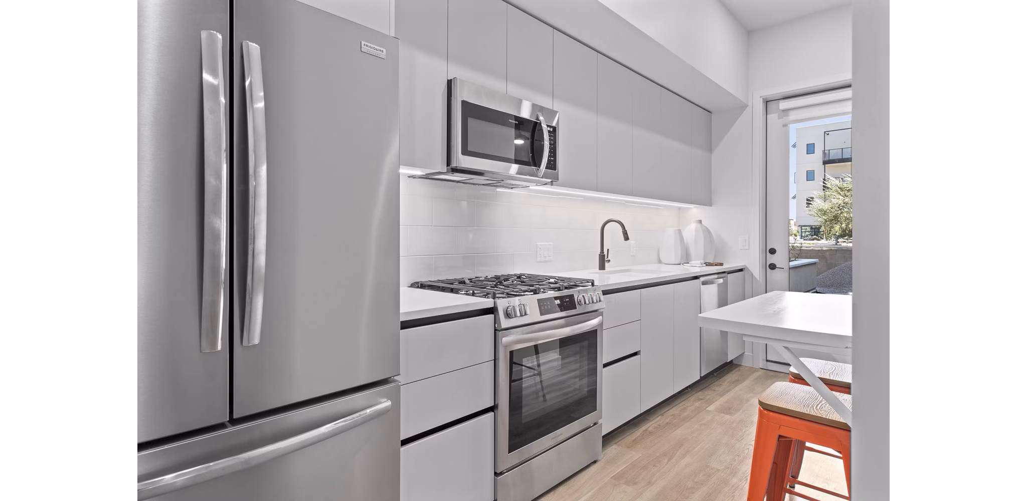 The Monde Scottsdale Apartments: Modern kitchen with stainless steel appliances and sleek cabinetry