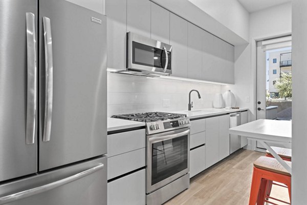 The Monde Scottsdale Apartments: Modern kitchen with stainless steel appliances and sleek cabinetry