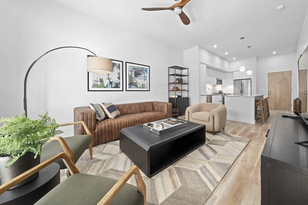 Spacious living room with modern decor in The Monde Scottsdale Apartments