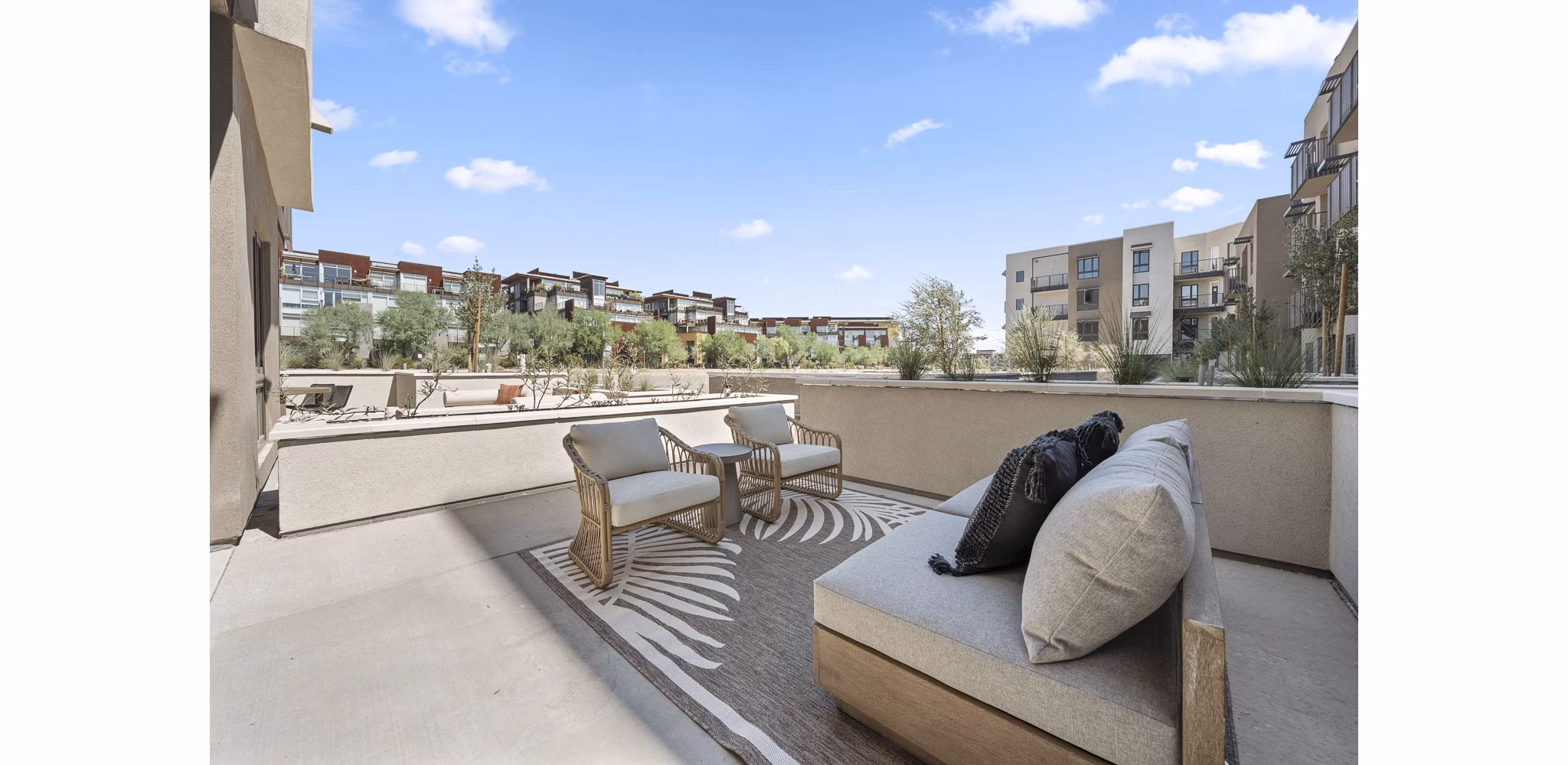 Stylish patio area with modern furnishings at The Monde Scottsdale Apartments, ideal for outdoor relaxation and social gatherings