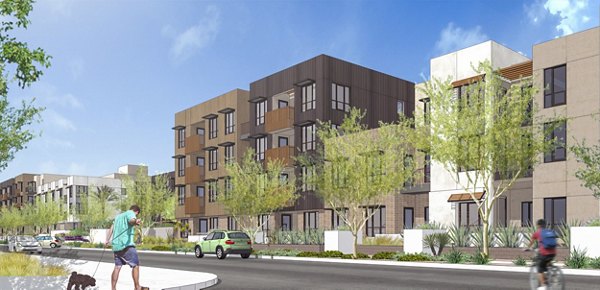 Swimming pool area with red Adirondack chairs and a modern apartment building in the background at luxury apartments