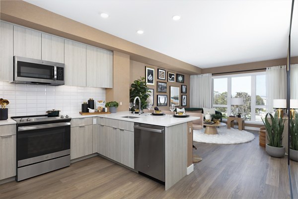 Modern kitchen with granite countertops and stainless steel appliances at Vasara Apartments