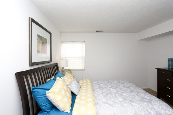 Modern bedroom with plush king-size bed and stylish decor at The M Club Apartments