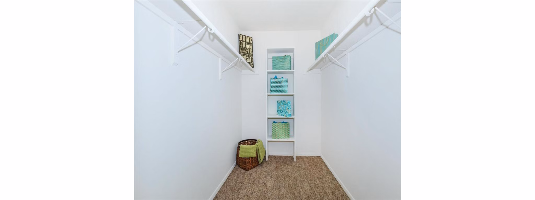 Closet with built-in shelving and ample storage space at The M Club Apartments