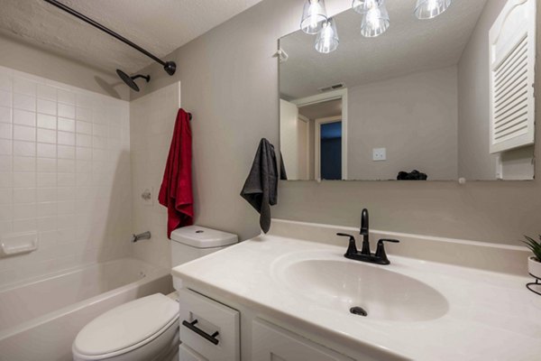 Modern bathroom featuring sleek fixtures and elegant tilework in The M Club Apartments