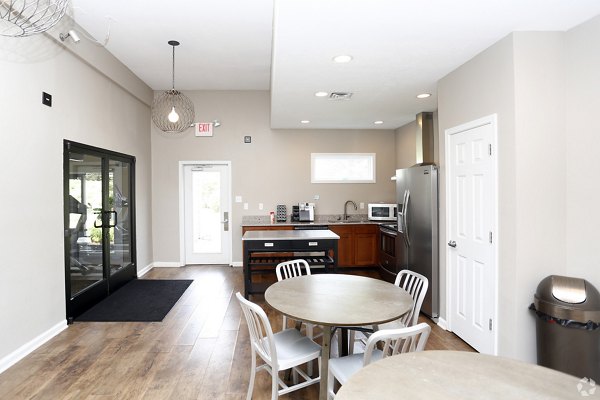 Modern clubhouse with communal seating and entertainment spaces at The M Club Apartments