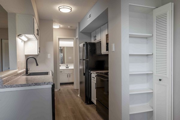 Modern kitchen with stainless steel appliances at The M Club Apartments