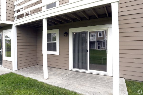 Spacious patio with stylish outdoor seating at The M Club Apartments