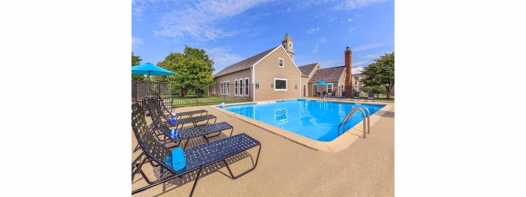 Resort-style pool with lounge chairs at The M Club Apartments offering luxury living in a vibrant community setting