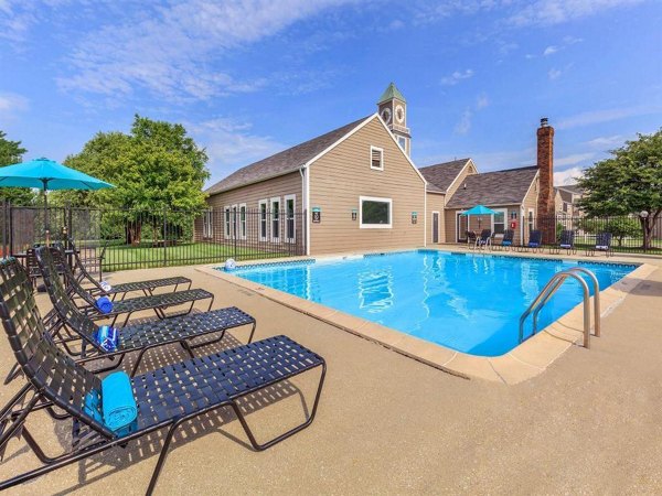 Resort-style pool with lounge chairs at The M Club Apartments offering luxury living in a vibrant community setting