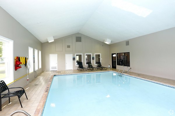 Indoor pool with modern design at The M Club Apartments offering a luxury swimming experience