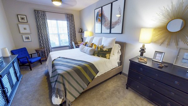 Cozy bedroom with plush bedding and modern decor at Indigo at Cross Creek Apartments