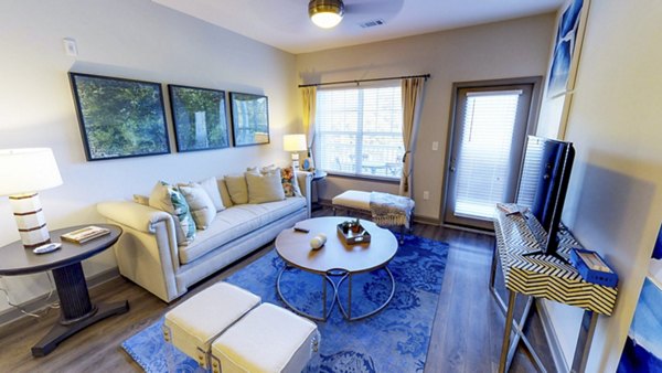 Cozy living room with modern furnishings in Indigo at Cross Creek Apartments