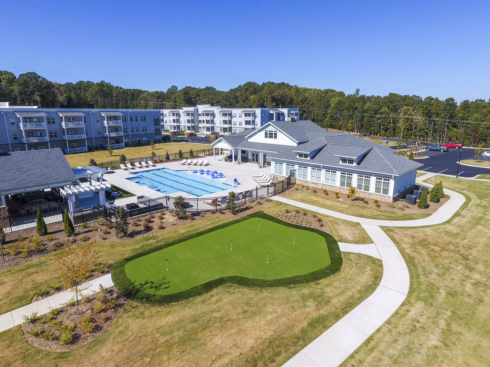 Putting green at Indigo at Cross Creek Apartments: Luxury amenity for residents to enjoy outdoor golfing activities Perfect leisure space in a serene setting