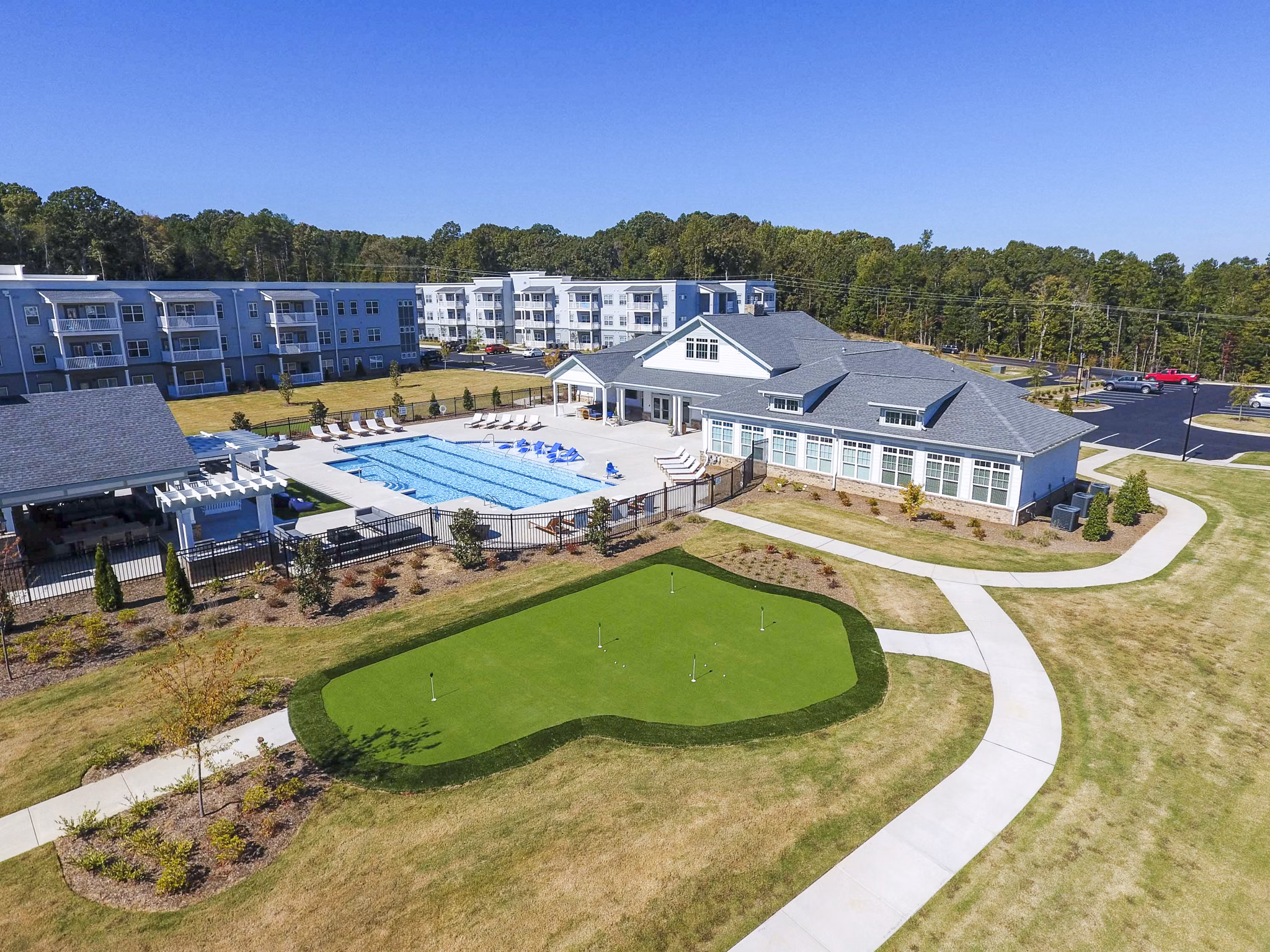 Putting green at Indigo at Cross Creek Apartments: Luxury amenity for residents to enjoy outdoor golfing activities Perfect leisure space in a serene setting