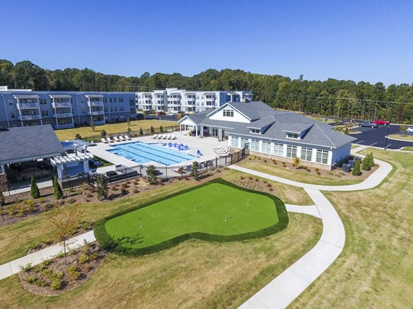 Putting green at Indigo at Cross Creek Apartments: Luxury amenity for residents to enjoy outdoor golfing activities Perfect leisure space in a serene setting