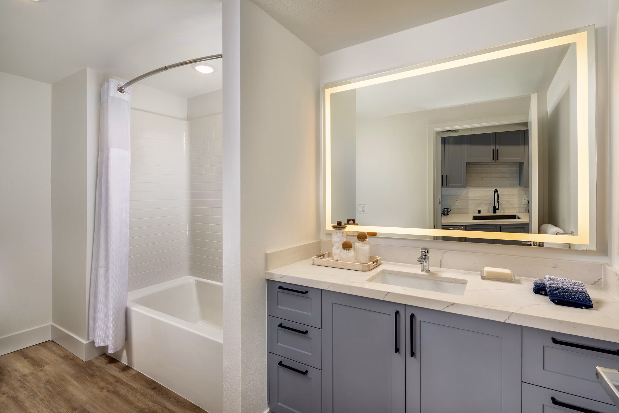 Modern bathroom with sleek fixtures and ample lighting at Lumia Apartments