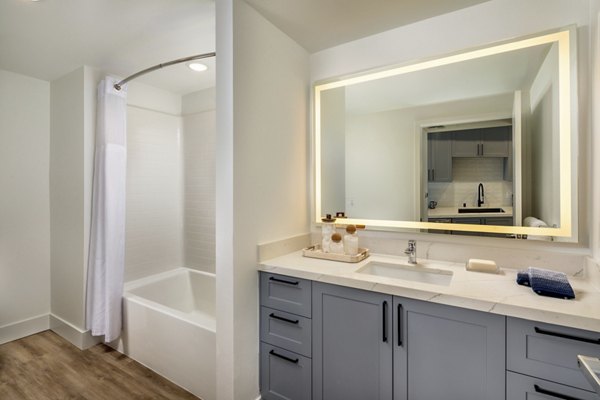 Modern bathroom with sleek fixtures and ample lighting at Lumia Apartments