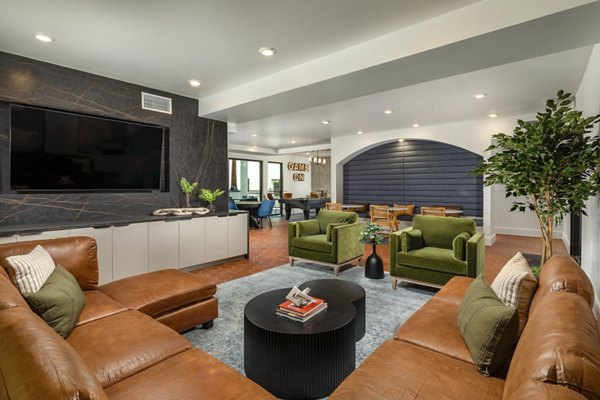 Modern game room with pool table and lounge seating at Lumia Apartments