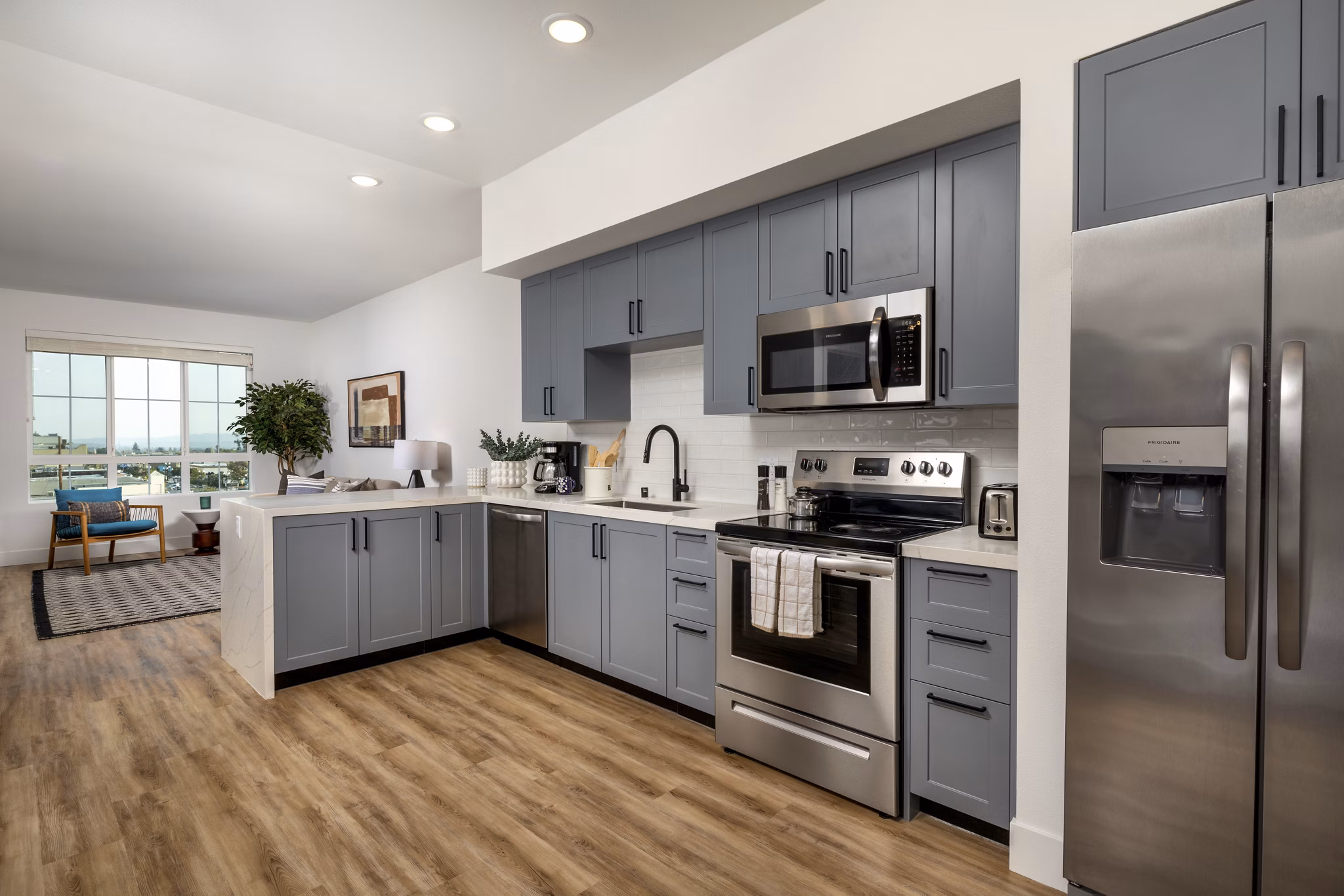 Modern kitchen featuring sleek countertops and stainless steel appliances in Lumia Apartments