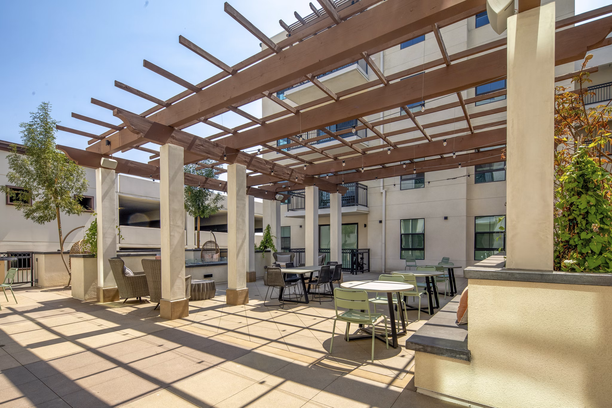 Outdoor grill area with modern patio furniture at Lumia Apartments