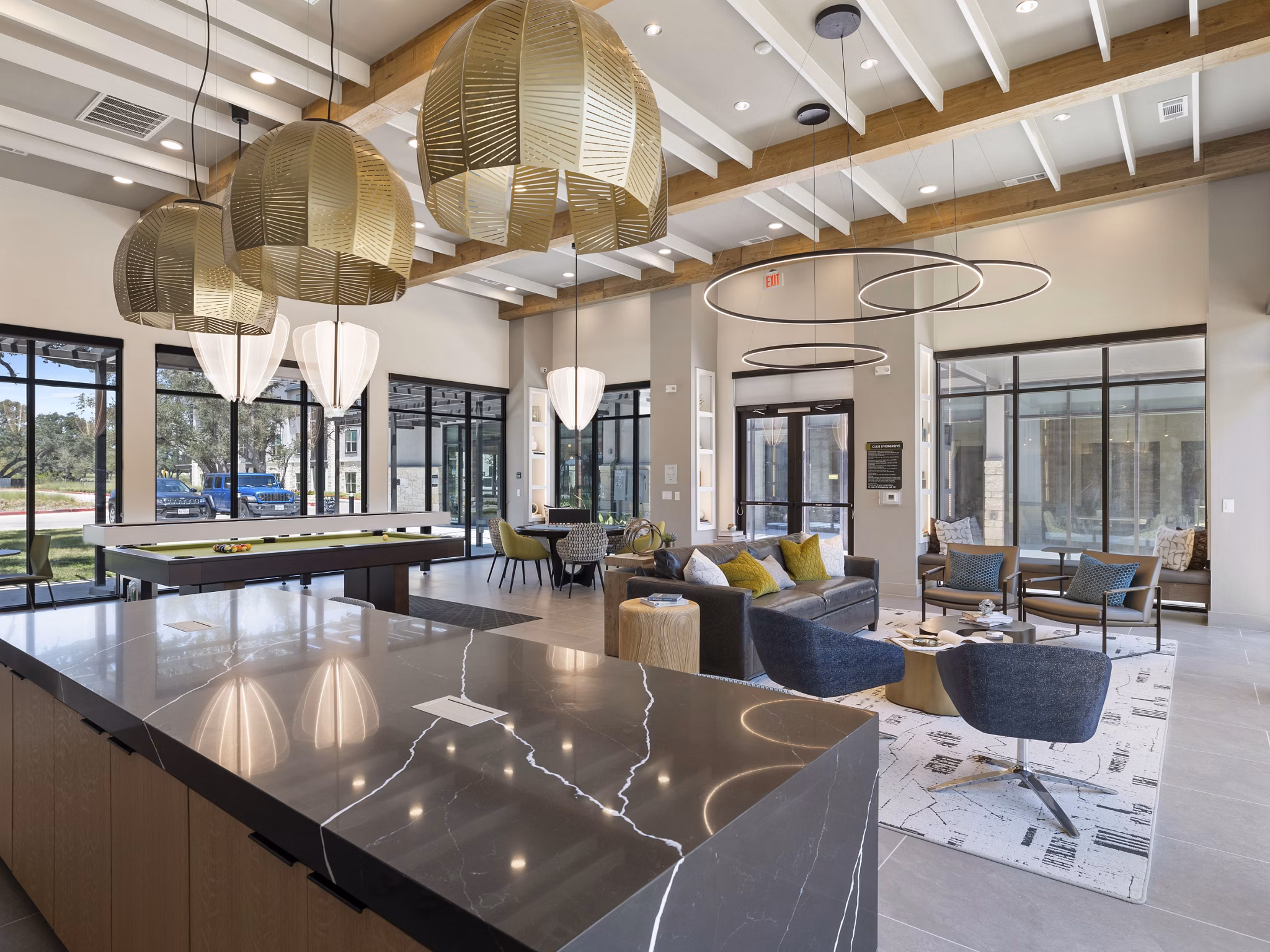 Game room featuring pool table and lounge seating at The Evergrove at Crystal Village Apartments