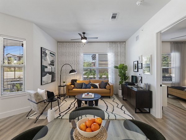 Spacious living room with modern furnishings in The Evergrove at Crystal Village Apartments