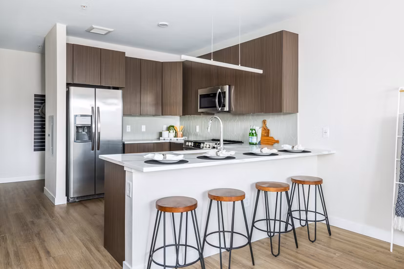 Modern kitchen with stainless steel appliances and quartz countertops at Park 40 Apartments, ideal for luxury living