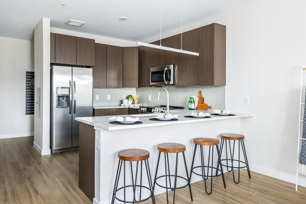 Modern kitchen with stainless steel appliances and quartz countertops at Park 40 Apartments, ideal for luxury living