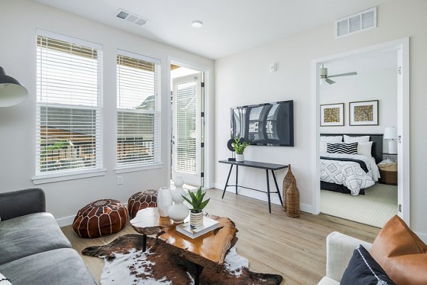 Spacious living room with modern decor and large windows at Park 40 Apartments