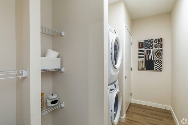 Laundry room with high-efficiency washers and dryers at Park 40 Apartments, a Greystar luxury community