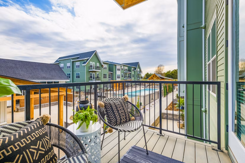Patio with modern furniture and lush greenery at Park 40 Apartments