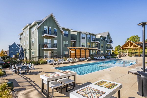 Luxurious poolside retreat at Park 40 Apartments with surrounding lounge chairs and greenery