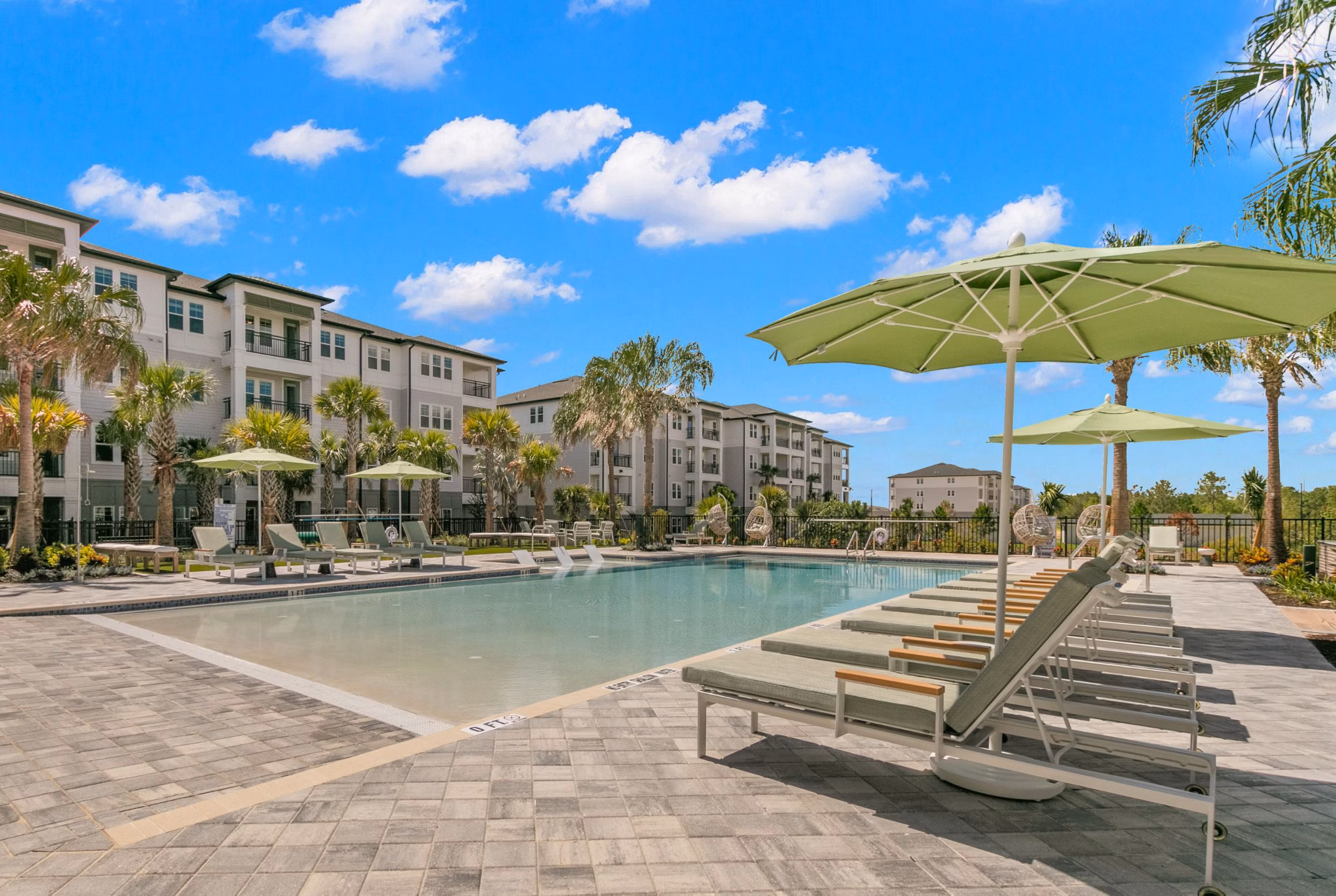 Resort-style pool with lounge chairs at Marlowe Ridgeview Apartments, offering luxury living and leisure amenities