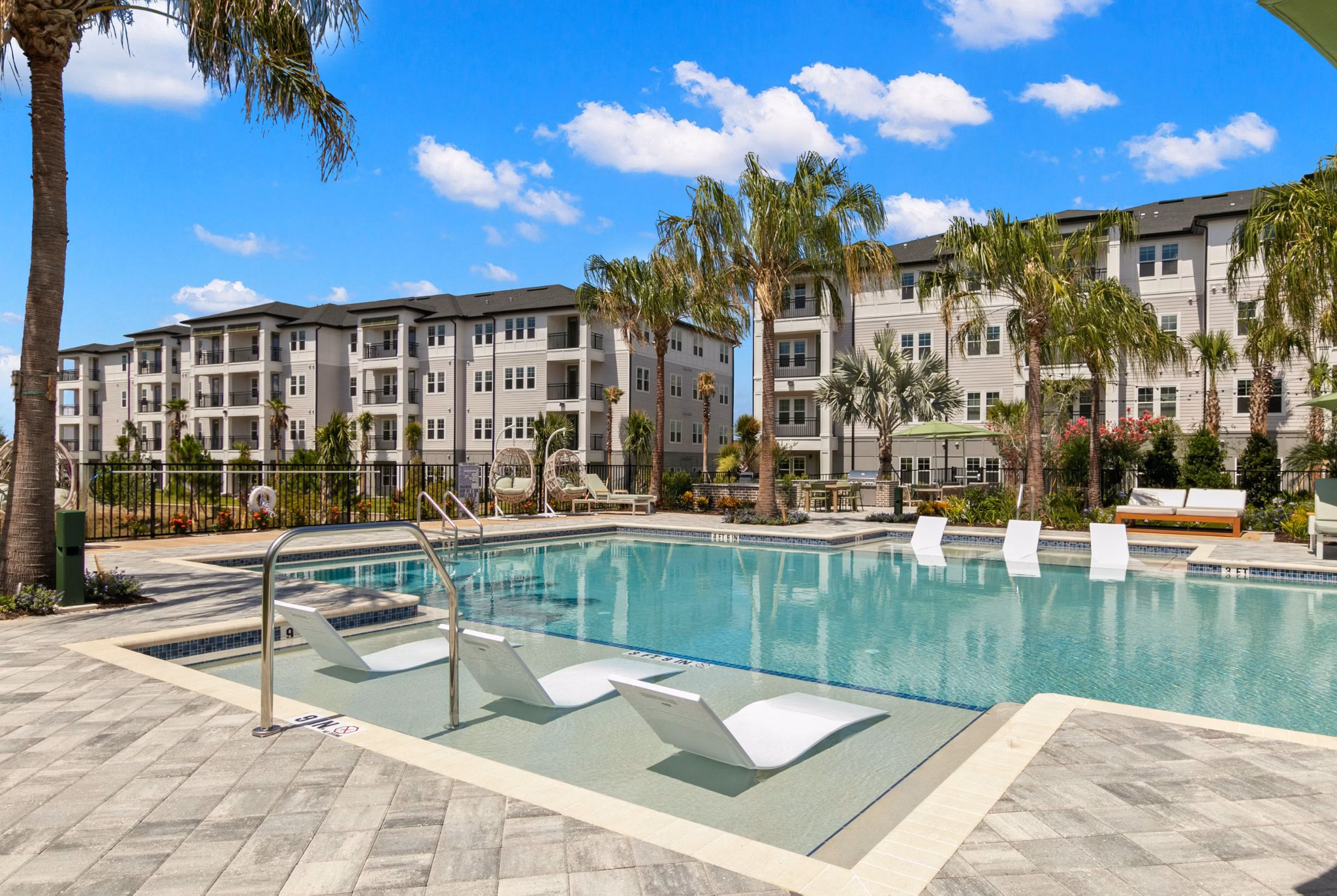 Marlowe Ridgeview Apartments: Chic pool area with relaxing lounge chairs and lush landscaping