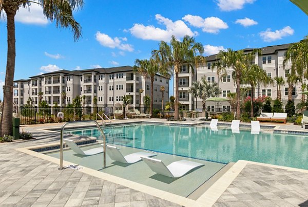 Marlowe Ridgeview Apartments: Chic pool area with relaxing lounge chairs and lush landscaping