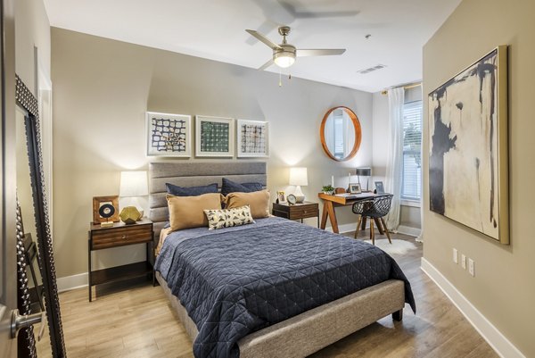 Spacious bedroom with modern decor at The Gibson Apartments in Charlotte, NC.