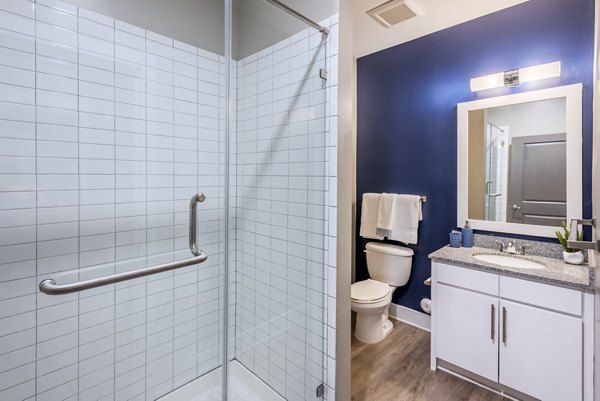 Boutique bathroom with quartz countertops and custom cabinetry at The Gibson Apartments, a luxury residence in the Greystar portfolio