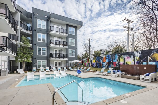 Luxurious pool with lounge chairs at The Gibson Apartments, offering resort-style relaxation and leisure in the heart of vibrant city living
