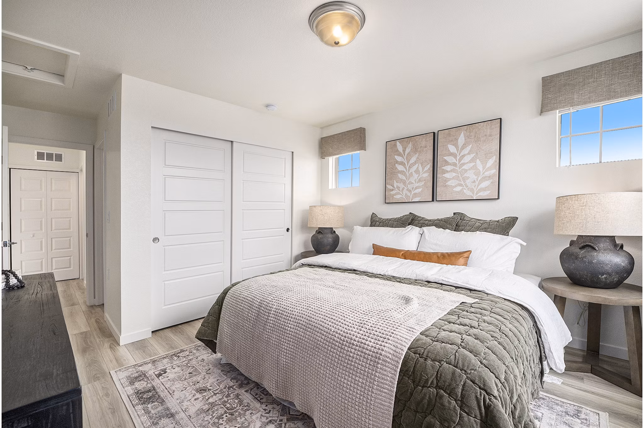 Cozy bedroom with elegant decor at The Cottages at Erie Commons Apartments
