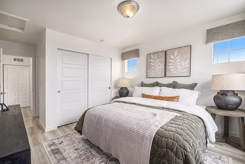 Cozy bedroom with elegant decor at The Cottages at Erie Commons Apartments