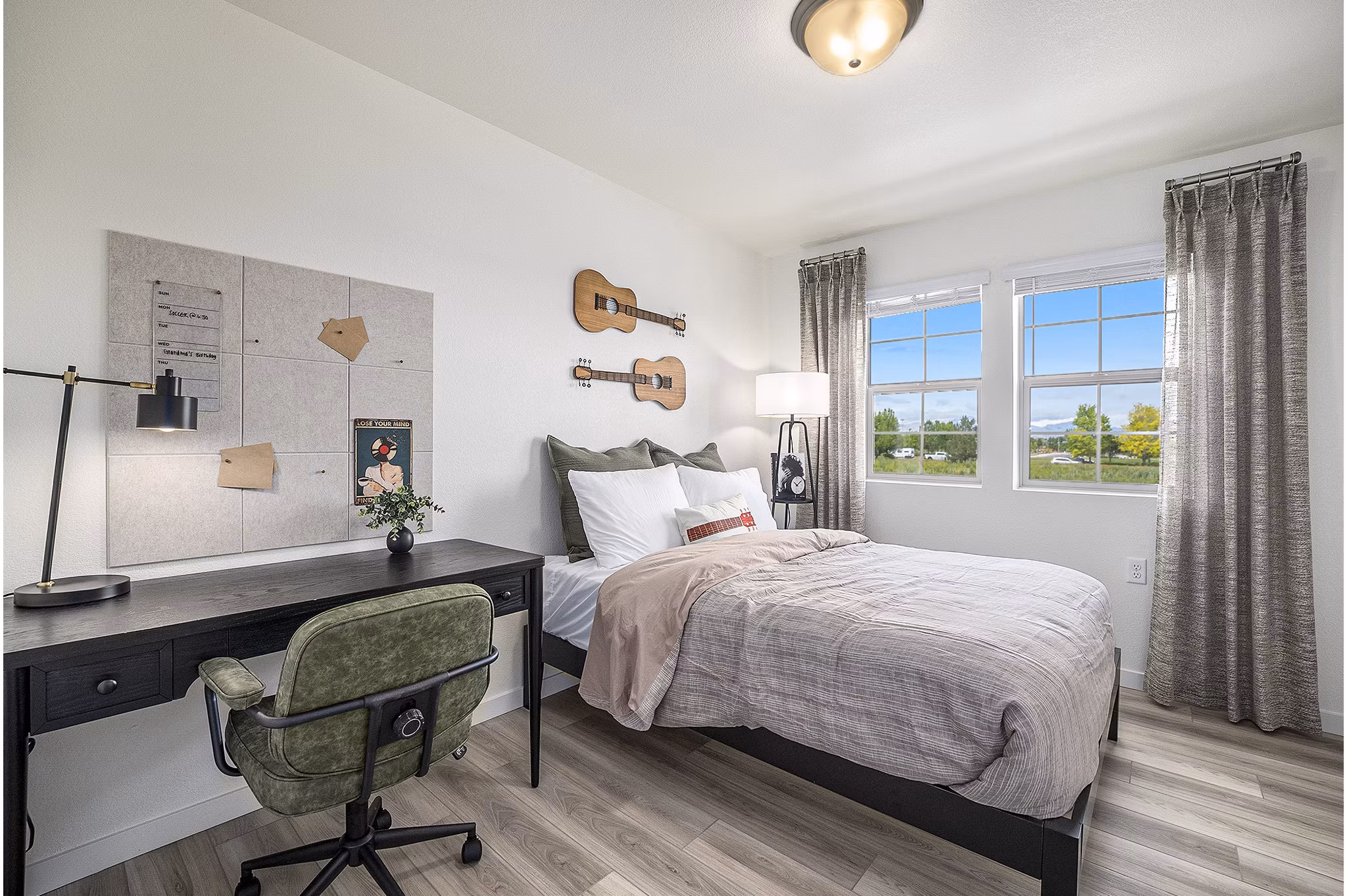 Bedroom featuring cozy decor and elegant furnishings at The Cottages at Erie Commons Apartments
