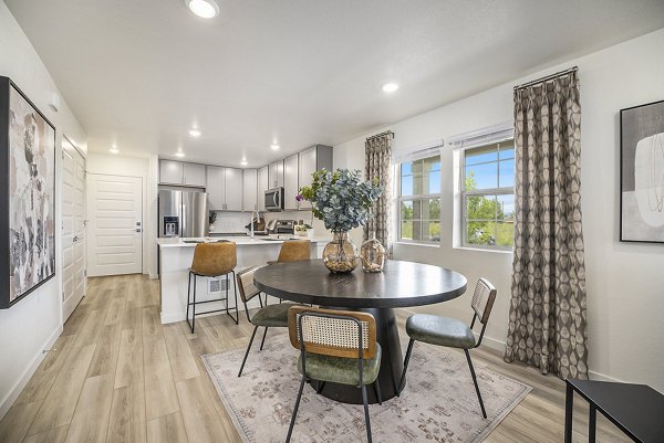 Dining area with modern furnishings at The Cottages at Erie Commons Apartments