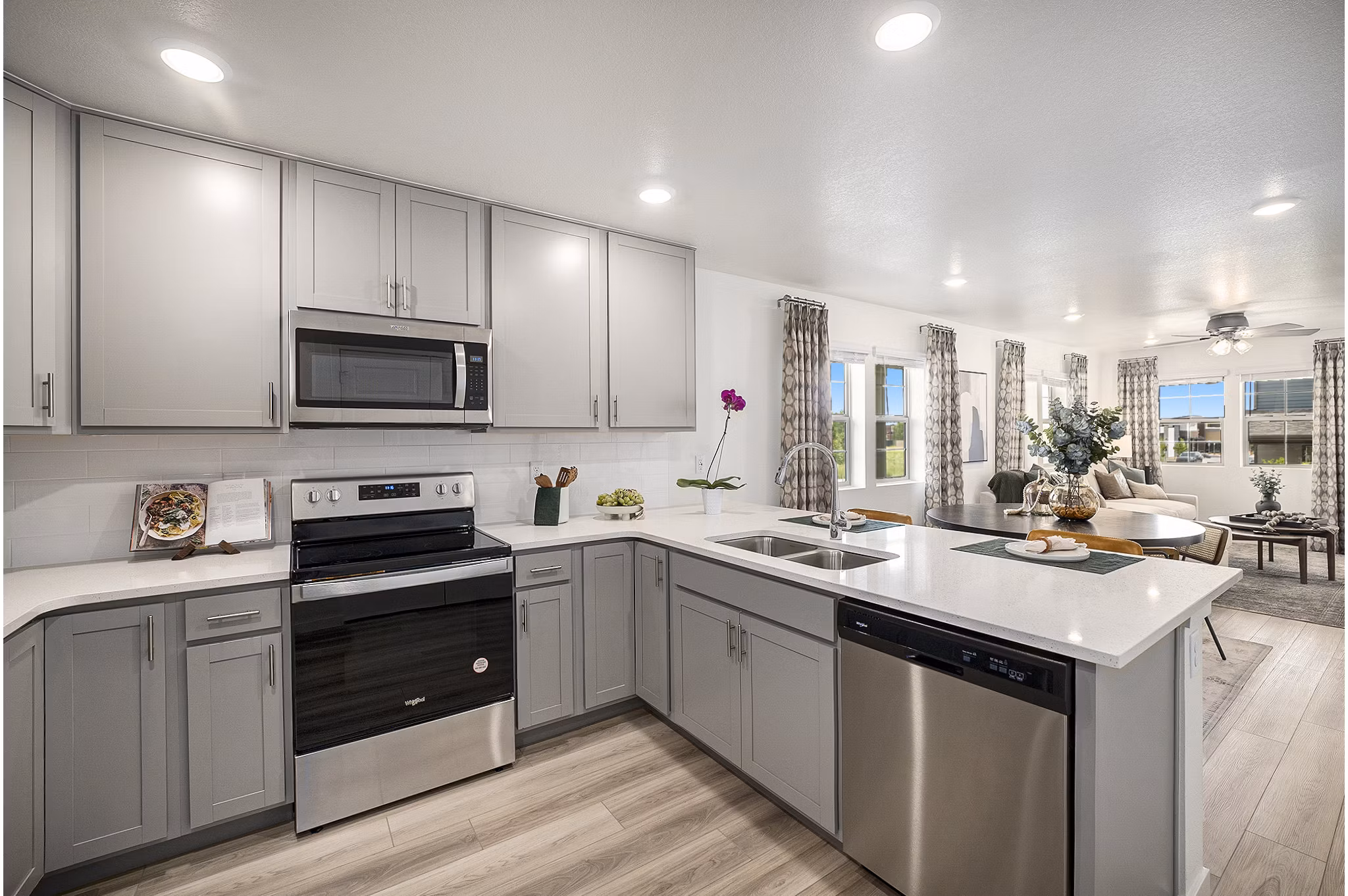 Modern kitchen with stainless steel appliances at The Cottages at Erie Commons Apartments in a Greystar community