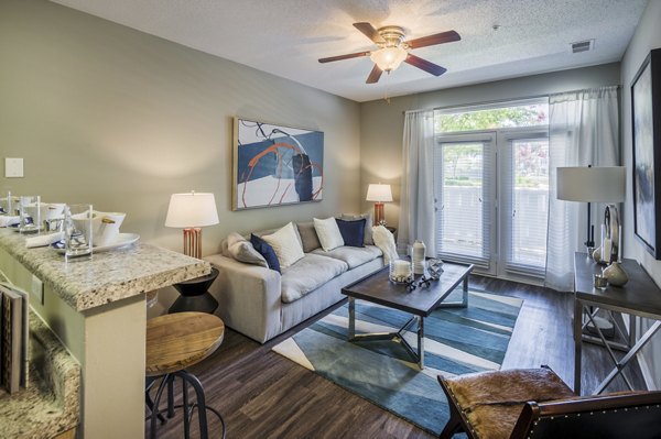 Spacious living room with modern decor in Arbor Steele Creek Apartments