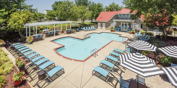Relaxing outdoor pool at Arbor Steele Creek Apartments featuring resort-style seating area