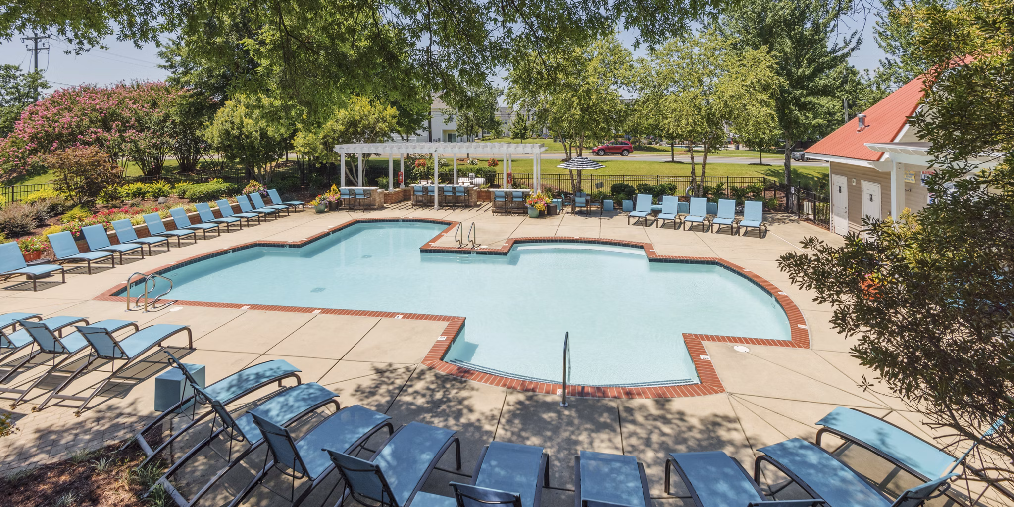 Rooftop pool with lounge chairs at Arbor Steele Creek Apartments